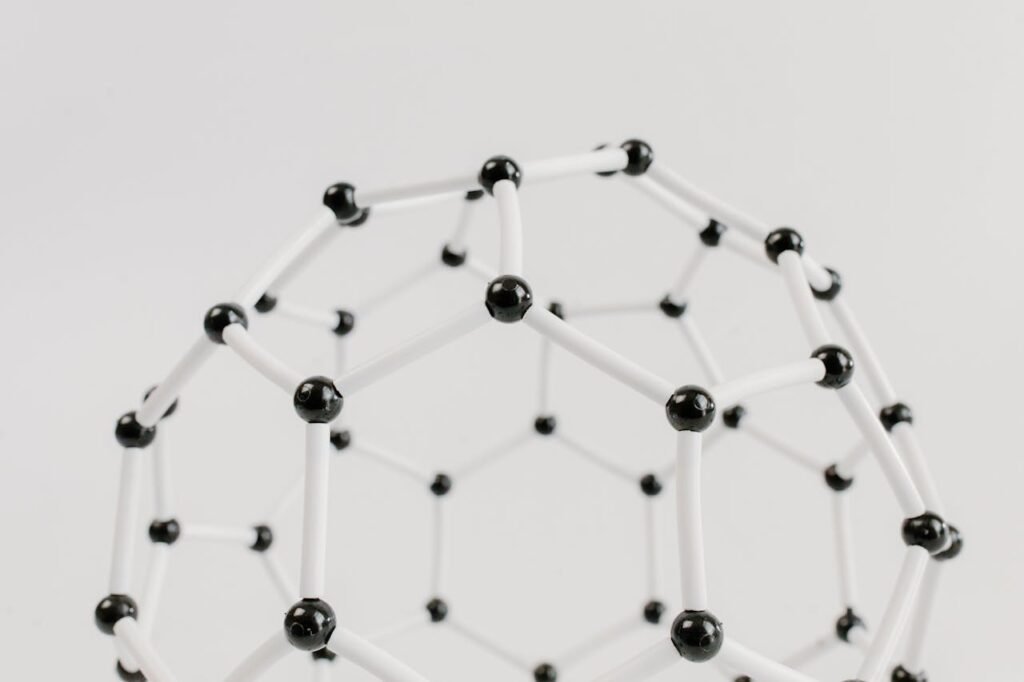 1. In Solids: Atoms Dance in Place
Think of an ice cube.

It looks solid. Hard. Still.

But its atoms are dancing!
They’re shaking in place—like kids wiggling in their chairs but not leaving their seats.

They don’t have space to run around, because they’re packed tightly together.
But they still jiggle.

That’s why solids can hold their shape.
The atoms are locked in—but they’re still alive with motion.

2. In Liquids: Atoms Slide Around
Now think of water.

In a glass, it sloshes, moves, and takes the shape of the glass.

That’s because the atoms in liquids are not stuck like in solids.
They can slide and move around each other.

They’re still close together—but they can squeeze by, like people bumping past each other in a crowded room.

This is why you can pour water and why it can splash.

Atoms in liquids love to move more freely.

3. In Gases: Atoms Fly Everywhere
Now picture steam coming out of a hot cup of tea.

That’s gas.

Atoms in gases are wild and free.
They move super fast.
They bounce, zoom, and spread out in all directions.

There’s lots of empty space between them, and they don’t want to stay in one place.

That’s why smells can travel, balloons can grow, and steam rises.

Gas atoms are like super dancers at a party, leaping and spinning with wild joy.

So What Makes Atoms Move Faster or Slower?
The answer is… temperature.

Let’s say that again:
Temperature is really just how fast atoms are moving.

Hot = fast-moving atoms

Cold = slow-moving atoms

Let’s look at some examples.

🔥 When You Heat Something Up
When you heat soup on the stove:

The atoms in the soup move faster and faster

They start bumping and jiggling harder

Some jump into the air as steam!

The hotter something gets, the more its atoms dance.

This is why:

Ice turns to water (atoms start slipping)

Water turns to steam (atoms start flying)

❄️ When You Cool Something Down
Now imagine putting water in the freezer.

What happens?

The atoms slow down

They stop sliding and start just shaking in place

The water becomes ice—a solid

This is because cold takes energy away.
Less energy = slower atoms.

They still move… just not as much.

But Wait… Do Atoms Ever Stop Moving Completely?
Good question.

Scientists have found that atoms can almost stop at something called absolute zero.

That’s -273 degrees Celsius (super, super cold).
Colder than Antarctica. Colder than space!

At that point, atoms move soooo slowly, they almost stop.

But here’s the cool thing:
They never really stop 100%.

There’s always just a little bit of wiggling left.

So the answer is:
Atoms never truly stop moving.

Why Does This Motion Matter?
You might be thinking: “Okay, so atoms move… so what?”

Well, it matters a lot! Because atomic motion:

Explains heat and cold

Explains how ice melts and water boils

Explains how smells travel

Explains why things mix, spread, and change

Let’s look at some real-life examples.

🍫 Chocolate in Your Hand
Hold a piece of chocolate.

If your hand is warm, it starts to melt. Why?

The heat from your hand makes the chocolate atoms move faster

They break away from their solid pattern

The chocolate becomes gooey

That’s atoms in motion, making a change you can feel (and taste!).

🌬️ Perfume Across a Room
Spray perfume in one corner of the room.

After a few seconds, you smell it on the other side.

How?

The perfume atoms are in a gas

They move fast and spread out

They bounce through the air and reach your nose

Even though you can’t see them, you can smell their movement.

🧊 Ice in a Drink
Drop ice cubes into water.

The cold ice atoms move slowly

The warmer water atoms move faster

When they meet, energy moves from water to ice

The ice melts and the water cools down

It’s like a dance party where some dancers are fast, some are slow, and they start moving together.

🌡️ Thermometers and Motion
Thermometers tell us how hot or cold something is.

But what they’re really doing is measuring how fast atoms are moving!

That’s right—your thermometer is like a motion detector for atoms!

The Big Idea: Atoms in Motion Make Life Possible
Without moving atoms:

No heat

No change

No smells

No food cooking

No energy

No life

The motion of atoms is what lets plants grow, water flow, and people live.

Everything depends on tiny invisible dancers working all the time.